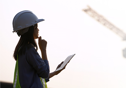 Female construction worker holding ipad