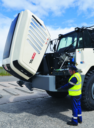 Image of worker performing maintenance on a truck