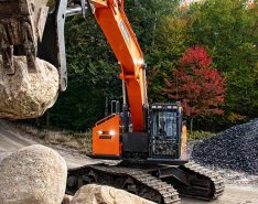Construction equipment lifting heavy rock 