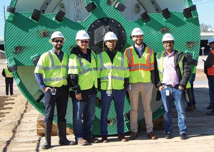 NETL project managers standing in front of the 135-inch earth pressure balancing tunnel boring machine used for tunneling at US-59