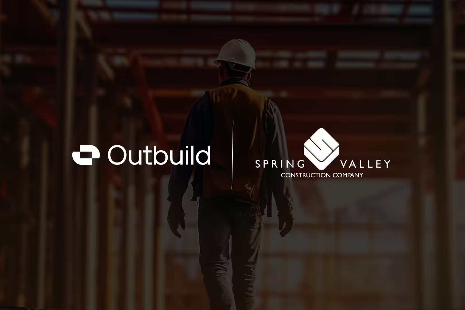 Construction worker walking through a job site with Outbuild and Spring Valley Construction Company logos displayed.