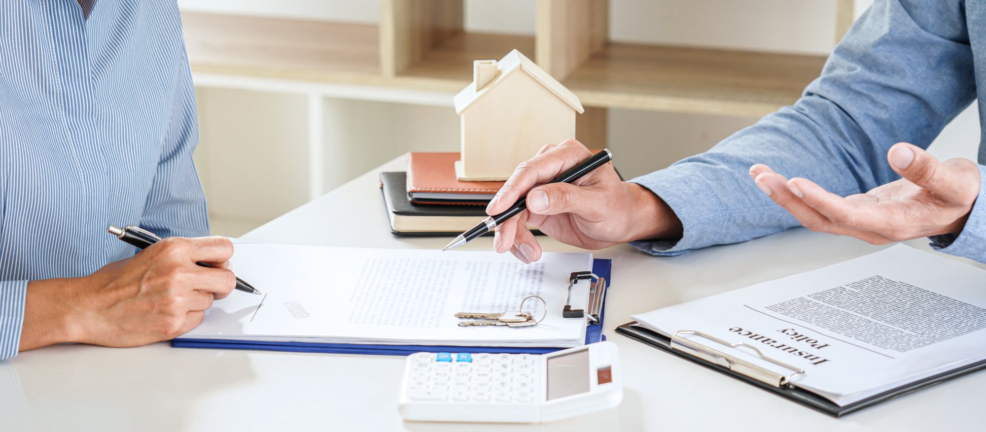 People signing insurance policy to indicate employment practices liability insurance