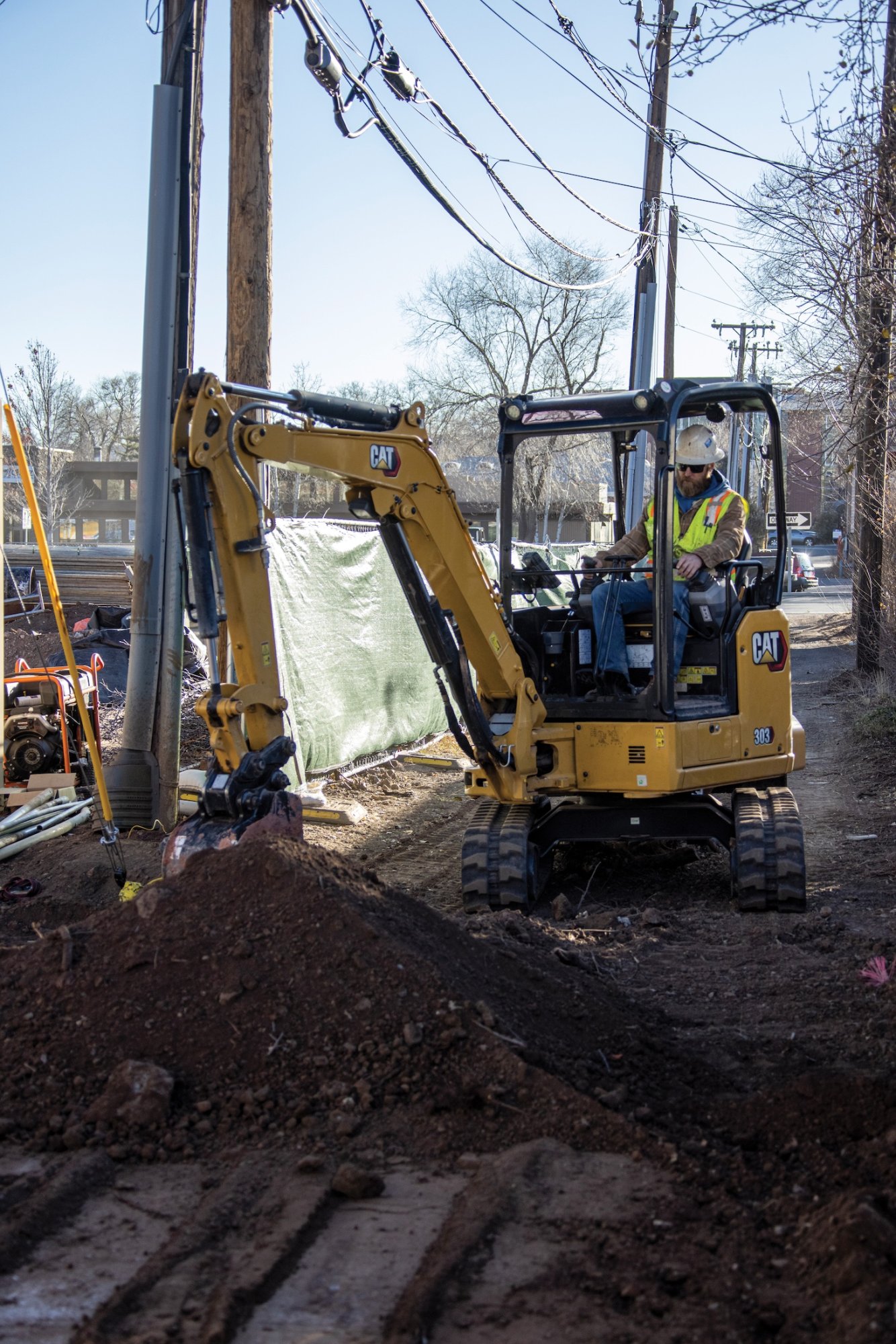 Cat 303.5 CR Mini Excavator working in a utility application