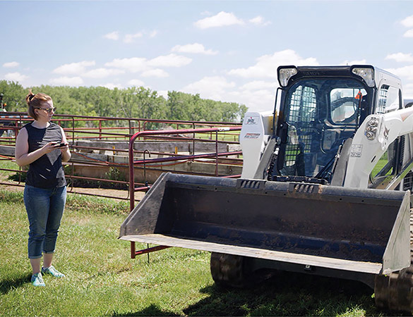 Woman operating Bobcat compact track loader