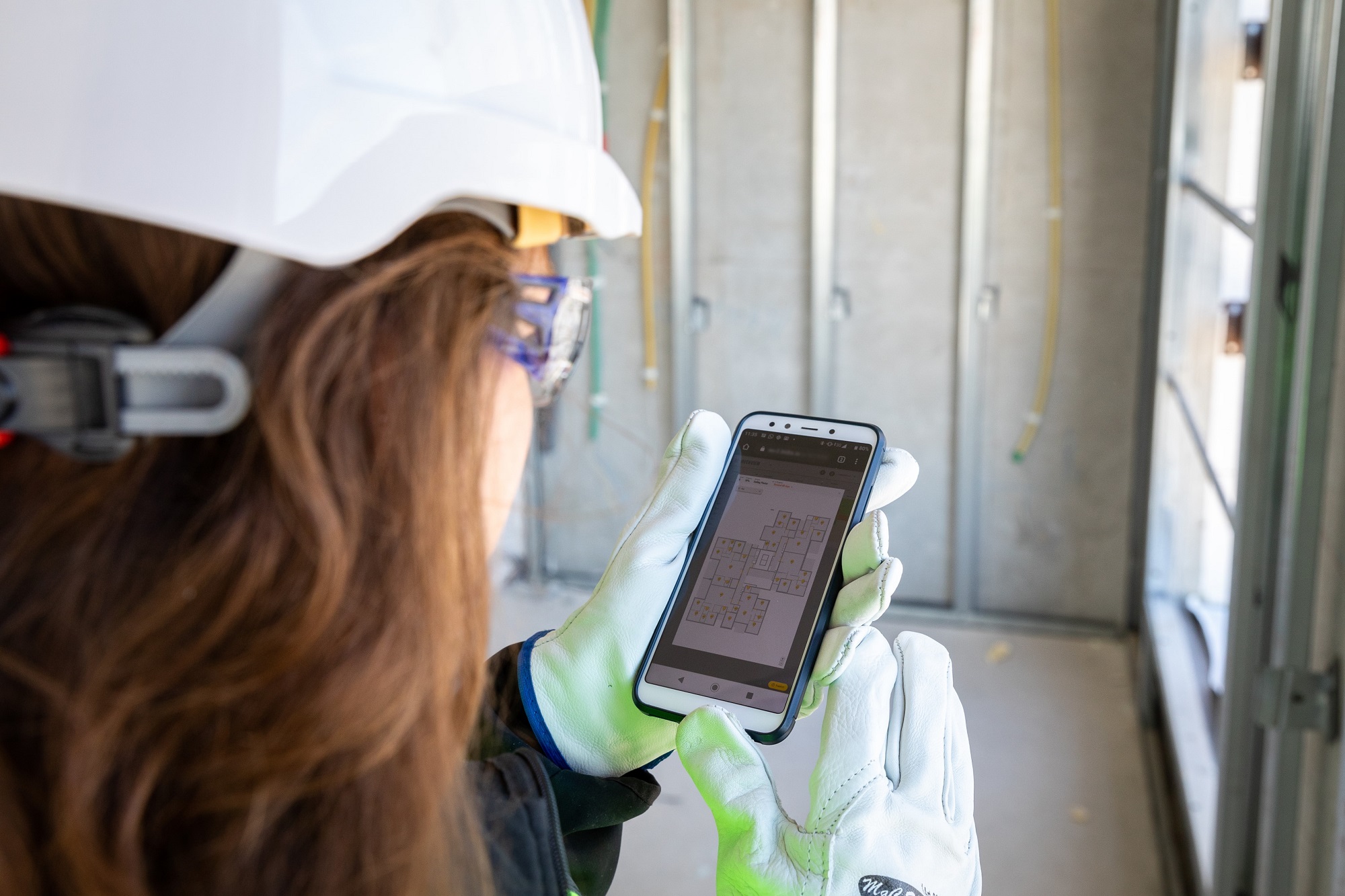 Female construction worker using software on the jobsite