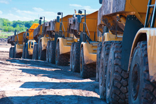 Row of articulated dump trucks