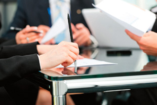 Group of professionals signing contracts