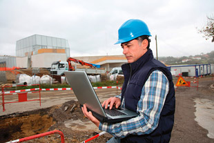 Contractor using laptop at jobsite