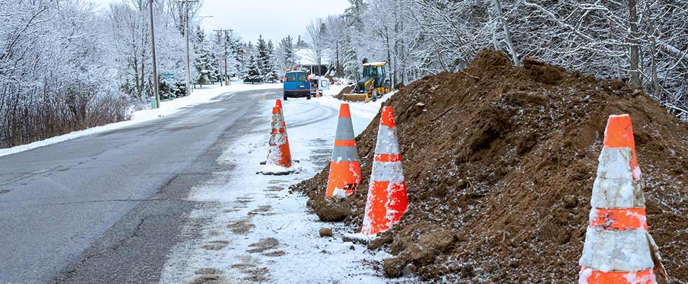 Snowy road with orange traffic cones