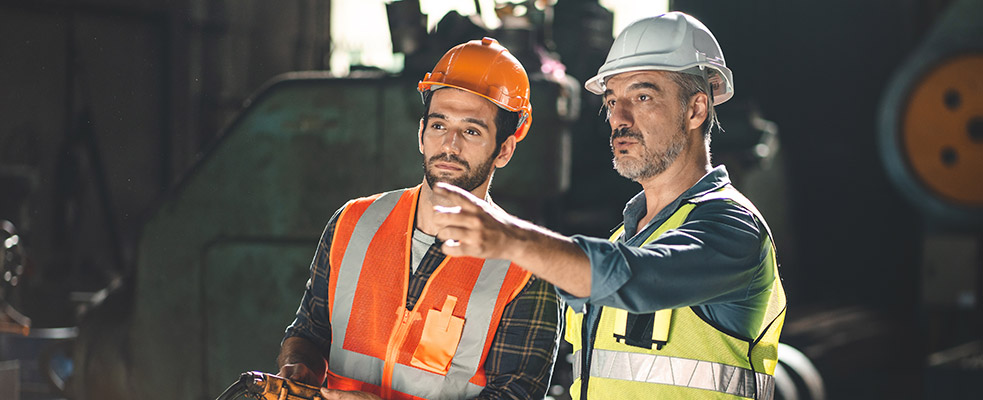 Two male construction workers looking off-camera