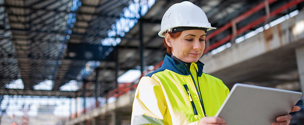 female construction worker looking at tablet