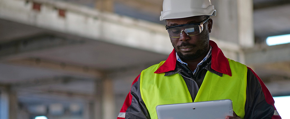 Construction worker looking at tablet
