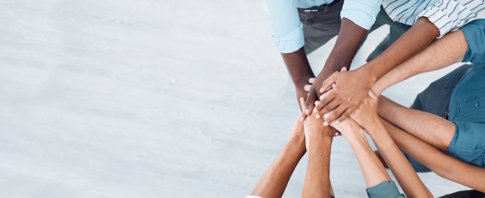 Team members stacking hands together
