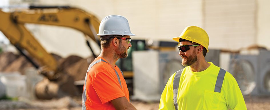 Two smiling construction workers to demonstrate a caring culture