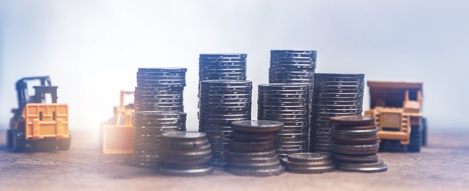 toy construction equipment approaching stacks of coins 
