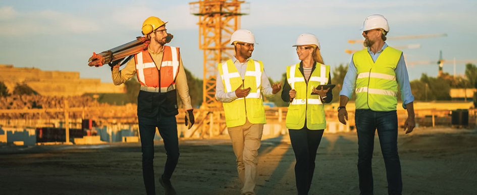 Construction workers happily talking/Adobe Stock
