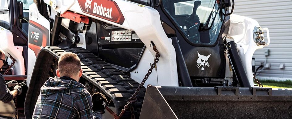 Person working on Bobcat machine