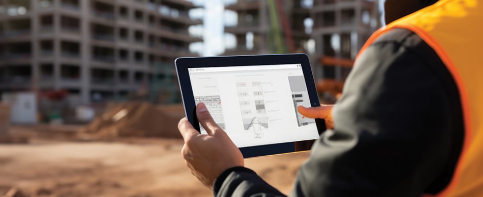 Worker in vest holding tablet