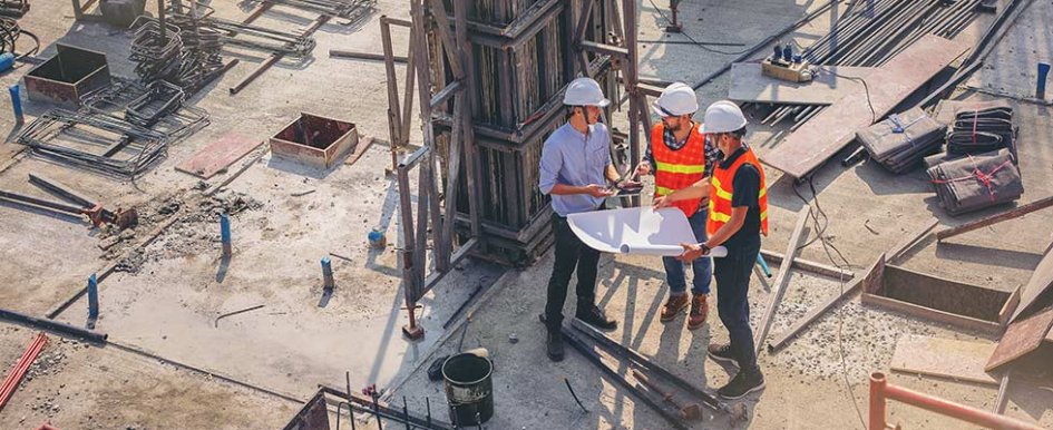 Three contractors looking at a plan