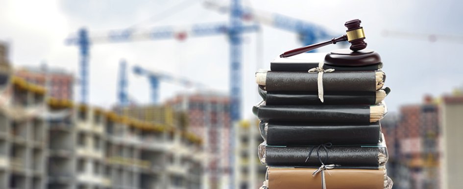 gavel in front of jobsite to illustrate construction law