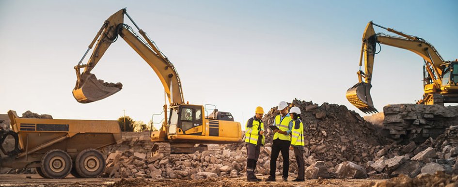 Construction workers on jobsite with equipment