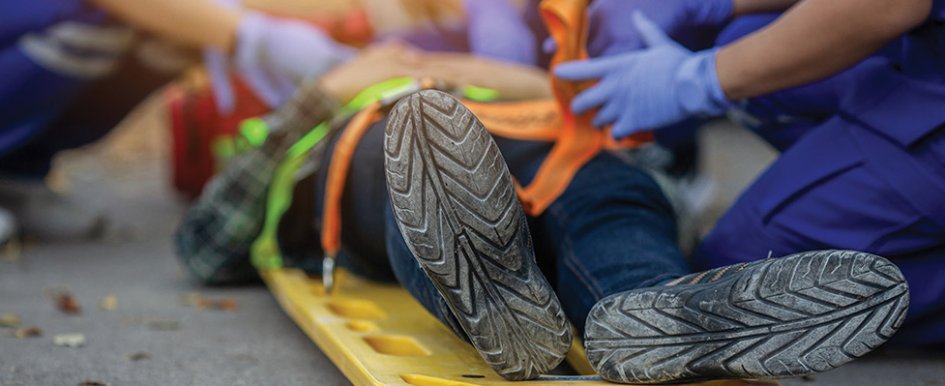 Injured construction worker surrounded by medical professionals