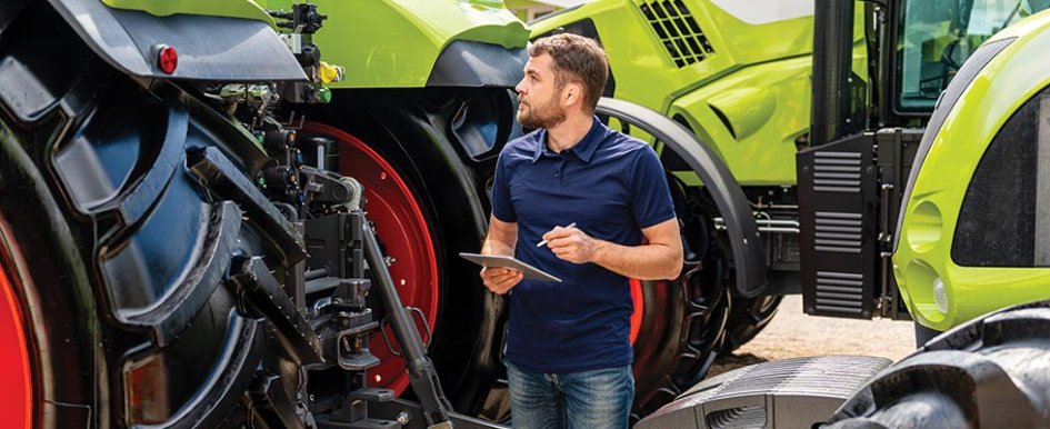 Man taking notes in front of construction fleet