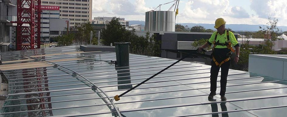 Construction worker in fall protection gear courtesy of Diversified Fall Protection