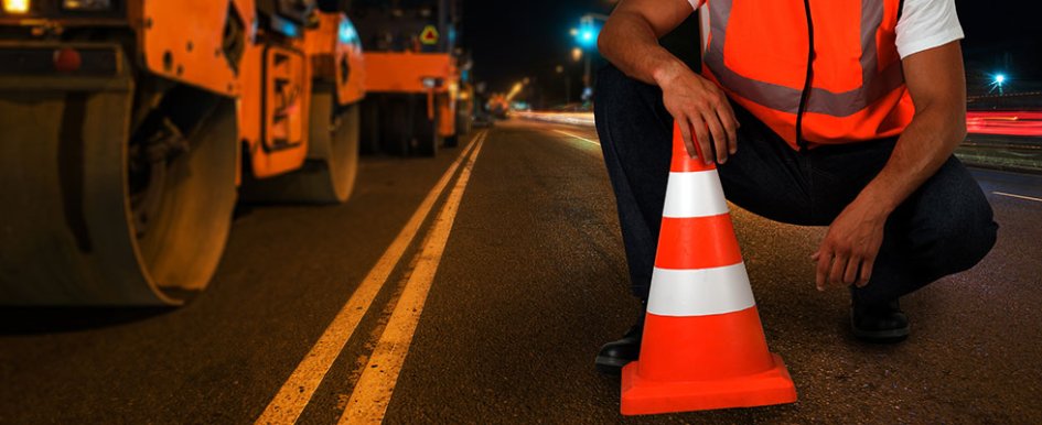 construction worker by traffic cone