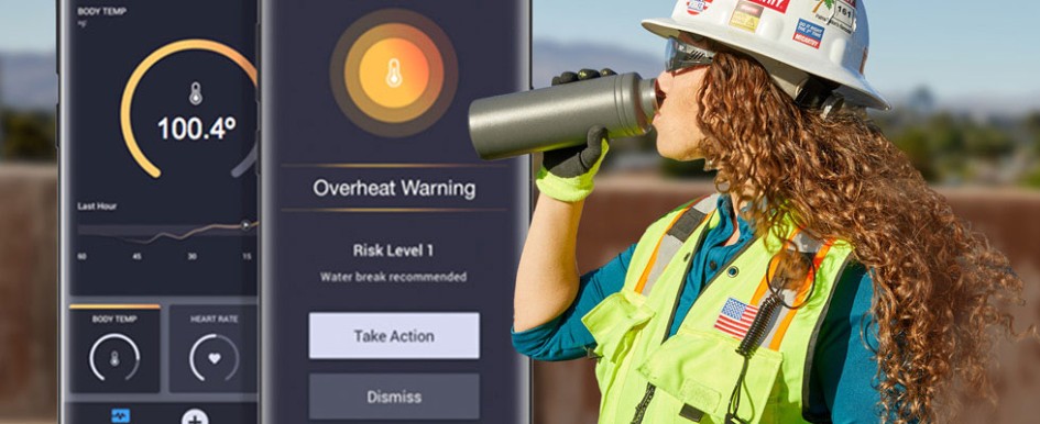 A woman with long curly hair, wearing a hard hat, a bright safety vest, sunglasses and gloves drinks from a water bottle. A phone screen can be seen displaying a temperature of one hundred degrees and text saying "overheat warning: risk level 1"