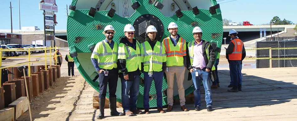 NETL project managers standing in front of the 135-inch earth pressure balancing tunnel boring machine used for tunneling at US-59