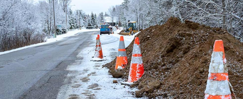 Snowy road with orange traffic cones