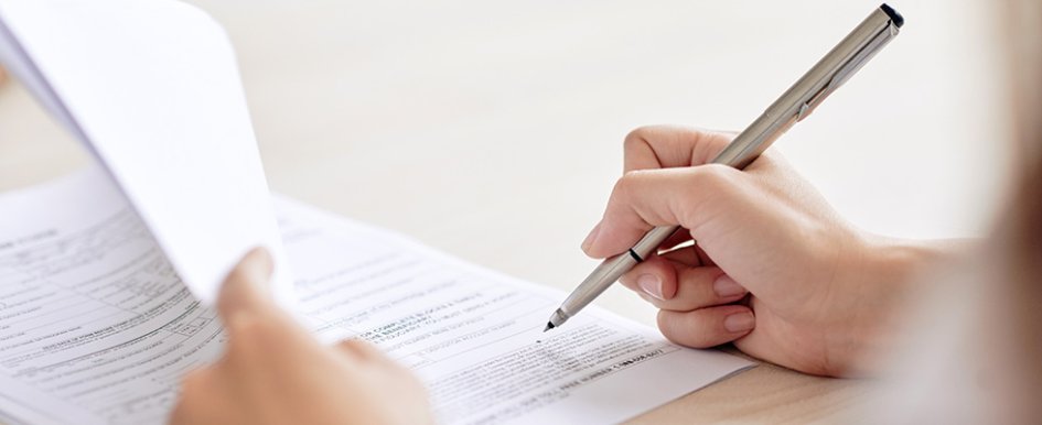 hand marking paper with a pen