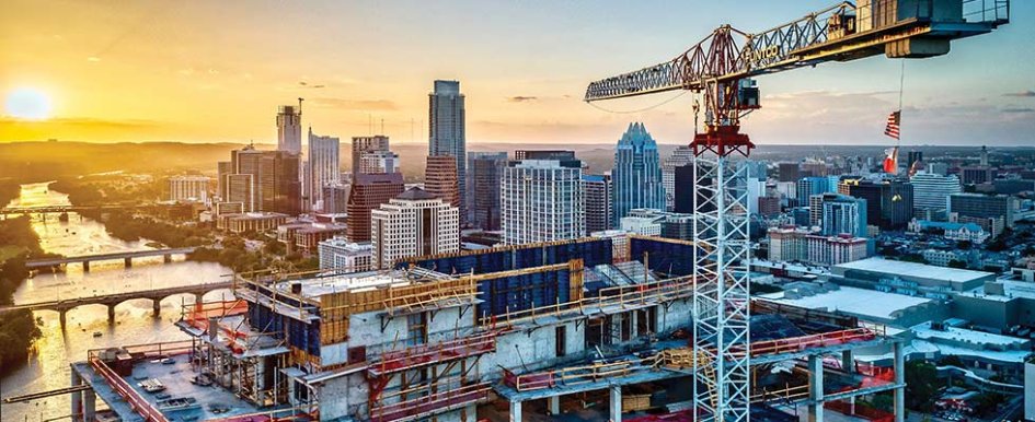 Construction equipment over city/Adobe Stock