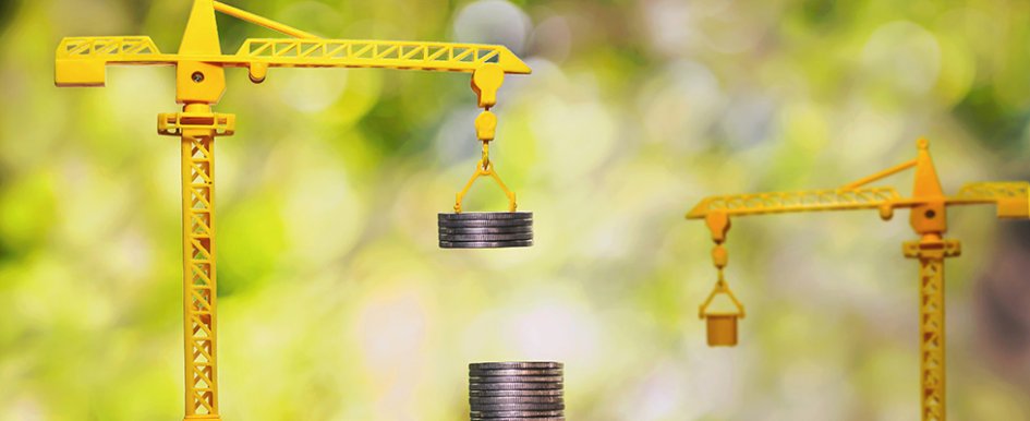 Toy cranes lifting and stacking coins
