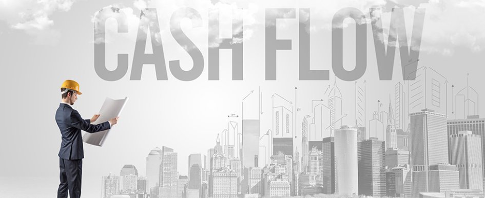 Man in hard hat standing in front of illustration of city with the words "cash flow" over it