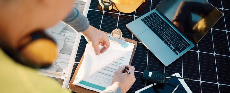 Worker looking at charts and laptop to illustrate subcontractor default insurance