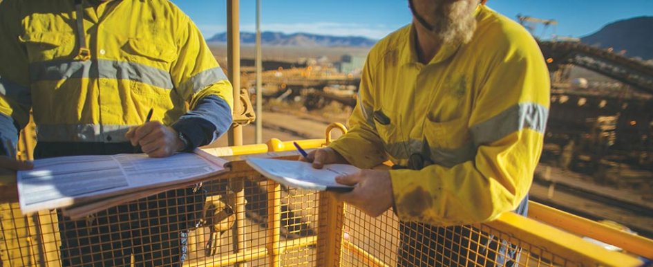 Construction workers completing paperwork on jobsite
