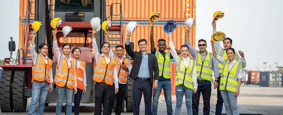 Workers holding hard hats/Adobe Stock