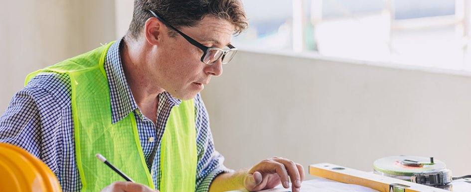 Man in vest working at desk