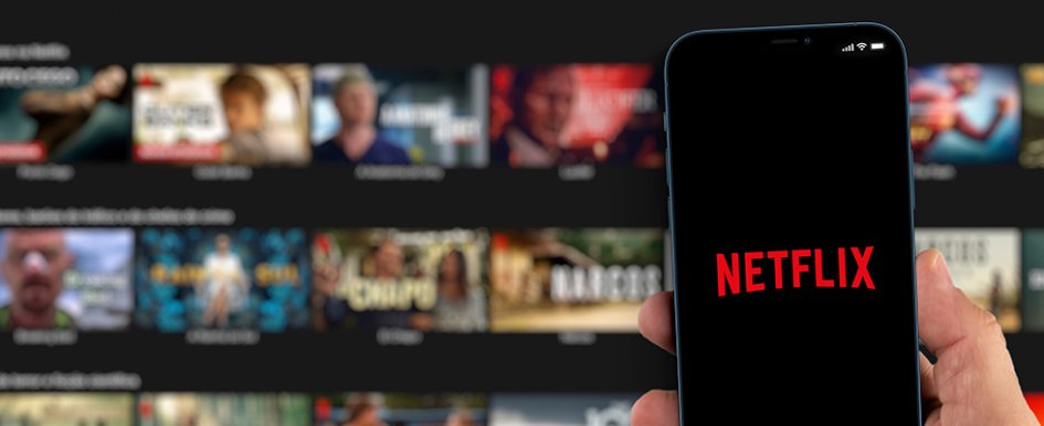 Smart phone with Netflix logo in front of larger screen showing Netflix library