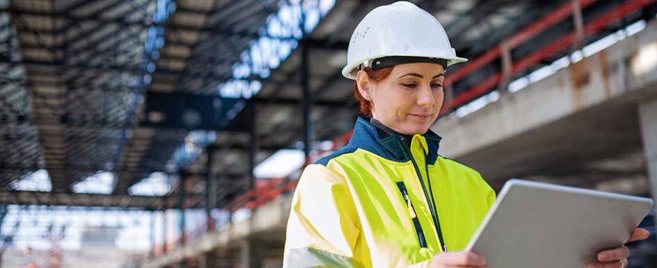 female construction worker looking at tablet