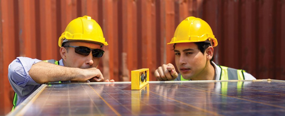 Two construction workers working together