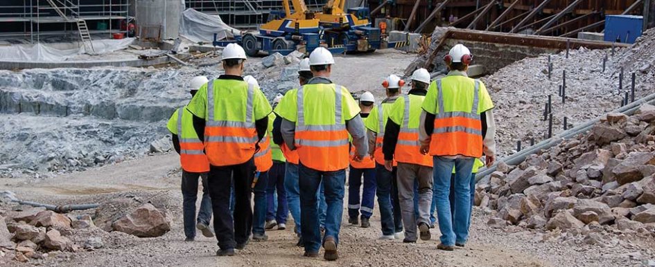 A group of construction workers walking to a jobsite to illustrate a strong workforce