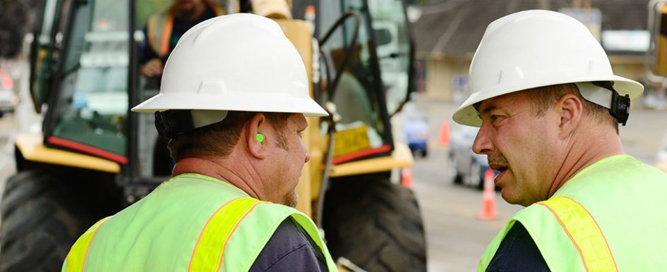 two construction workers talking