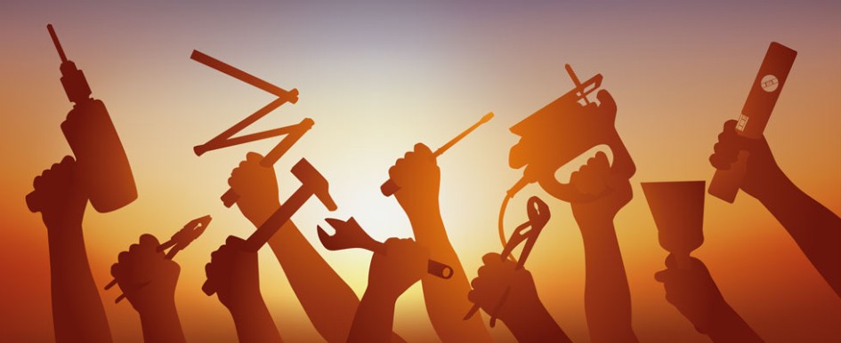 Ten hands holding various tools are silhouetted against a yellow and orange gradient background