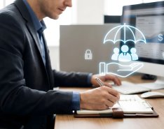 Businessman reviewing insurance coverage on computer