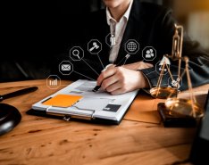 person signing legal documents at desk