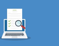 Laptop displaying checklist under magnifying glass