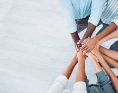 Team members stacking hands together